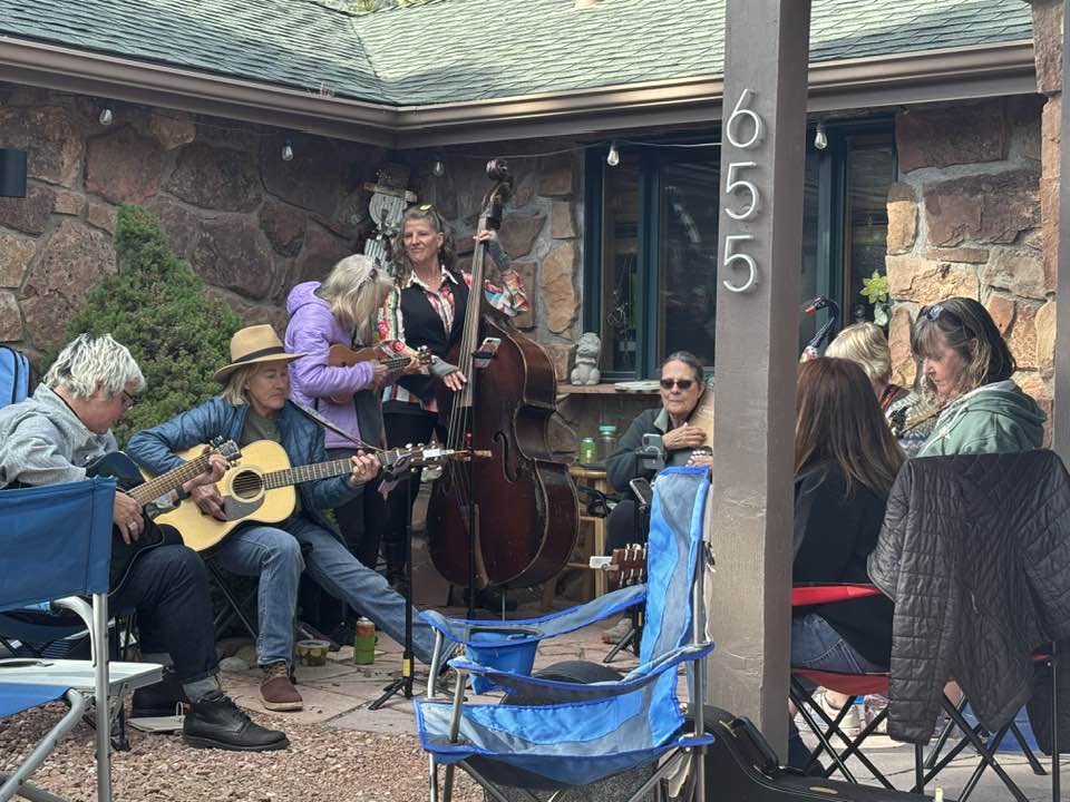 driveway happy hour gathering Pinewood Springs Colorado neighbors playing music together