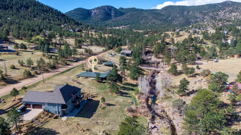 aerial view of Pinewood Springs home along Little Thompson River foothills setting